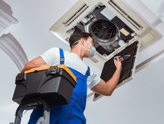 worker repairing ceiling air conditioning unit 1 min